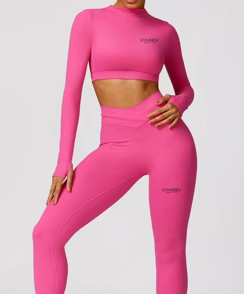 Vibrant hot pink gym outfit featuring a long sleeve crop top and matching high waist leggings from Gym Geek