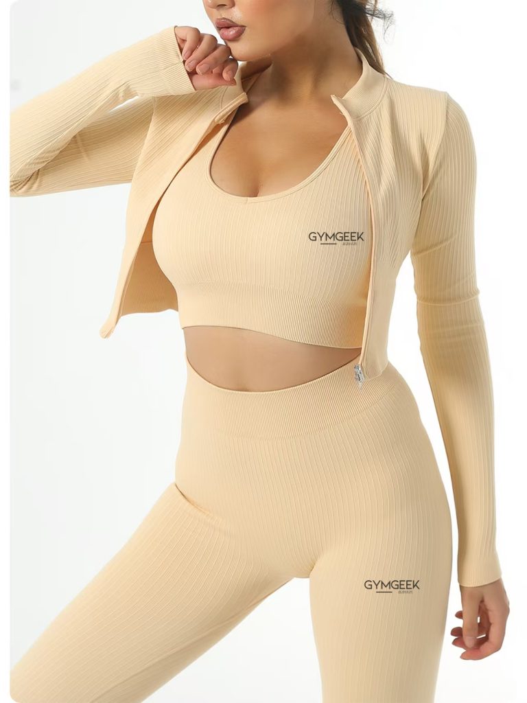 Gymgeek’s beige midi zip-up jacket, top, and leggings set, designed for comfort and style in one coordinated look.